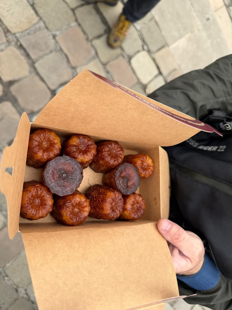 A box of fresh canelés from a Bordeaux bakery